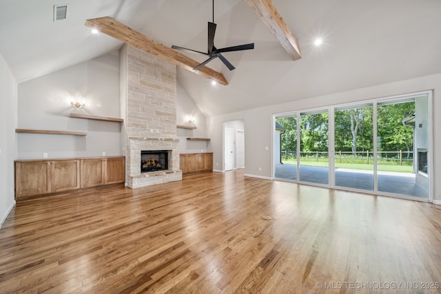 682 W 113th Ct S, Jenks, OK 74037 - unfurnished living room featuring ceiling fan, high vaulted ceiling, wood finished floors, beamed ceiling, and a fireplace