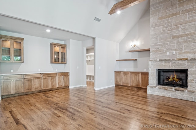 682 W 113th Ct S, Jenks, OK 74037 - unfurnished living room with high vaulted ceiling, light wood-type flooring, and a fireplace