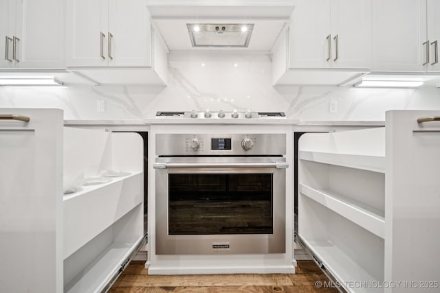682 W 113th Ct S, Jenks, OK 74037 - kitchen featuring stainless steel oven, white cabinets, range hood, and light wood-style floors