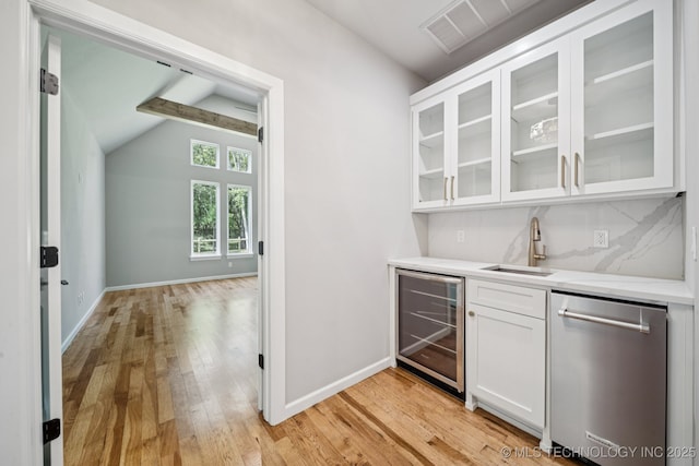 682 W 113th Ct S, Jenks, OK 74037 - indoor wet bar featuring beverage cooler, stainless steel dishwasher, light wood-type flooring, tasteful backsplash, and lofted ceiling