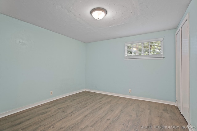 532 Hammers Rd, Ardmore, OK 73401 - unfurnished bedroom featuring wood finished floors, baseboards, and a closet