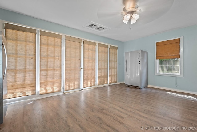 532 Hammers Rd, Ardmore, OK 73401 - unfurnished bedroom with freestanding refrigerator, wood finished floors, baseboards, multiple closets, and ceiling fan