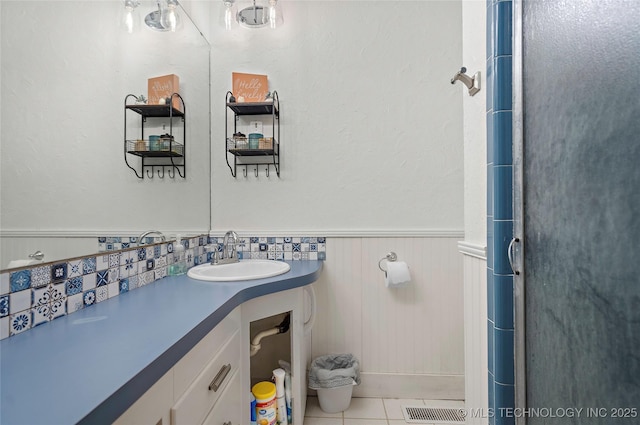 532 Hammers Rd, Ardmore, OK 73401 - bathroom featuring vanity, a wainscoted wall, tile patterned flooring, and a shower with door