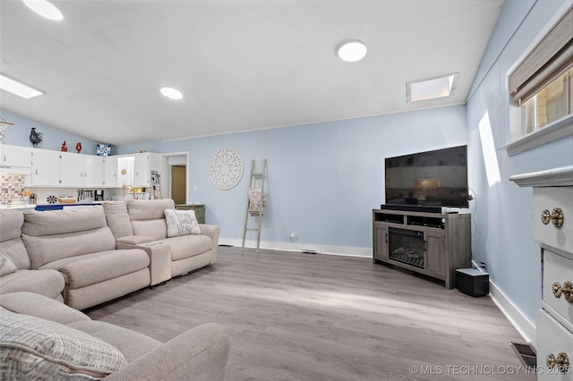 532 Hammers Rd, Ardmore, OK 73401 - living area with light wood-style flooring, a fireplace, baseboards, and recessed lighting