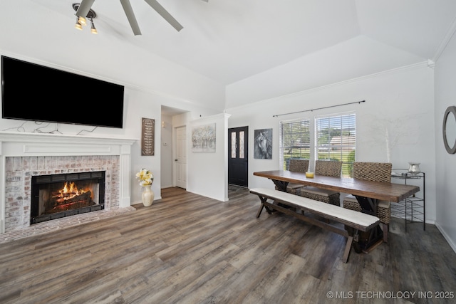 27108 E 82nd St S, Broken Arrow, OK 74014 - dining area with wood finished floors, baseboards, lofted ceiling, ceiling fan, and a brick fireplace