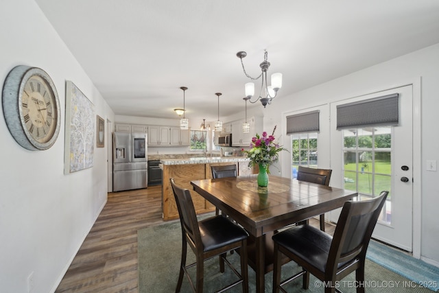 27108 E 82nd St S, Broken Arrow, OK 74014 - dining space with a chandelier, dark wood-style flooring, and baseboards
