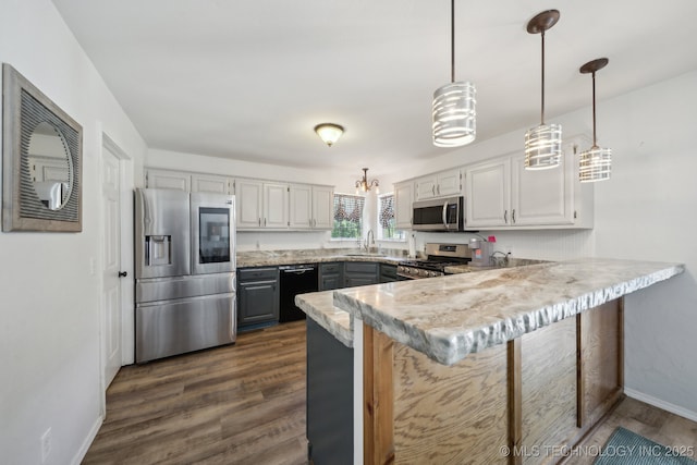 27108 E 82nd St S, Broken Arrow, OK 74014 - kitchen with appliances with stainless steel finishes, a peninsula, light countertops, baseboards, and dark wood-style floors