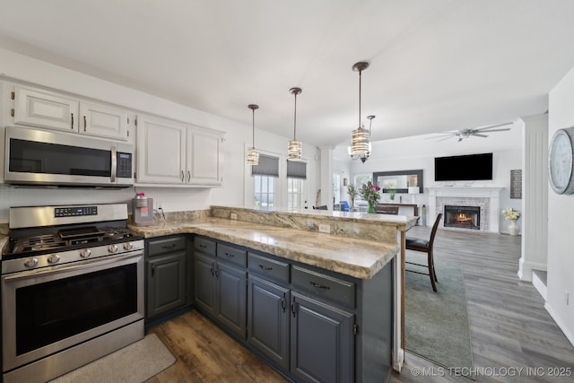 27108 E 82nd St S, Broken Arrow, OK 74014 - kitchen with appliances with stainless steel finishes, a peninsula, white cabinetry, ceiling fan, and gray cabinetry