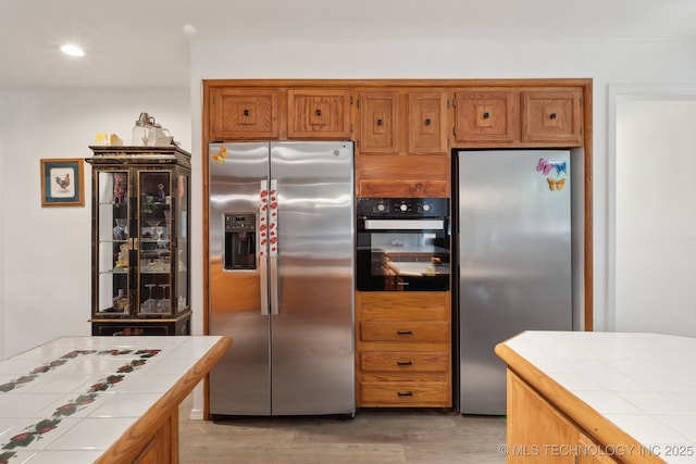 239 Seneca Dr, Sand Springs, OK 74063 - kitchen featuring stainless steel fridge with ice dispenser, stainless steel refrigerator, tile countertops, oven, and recessed lighting
