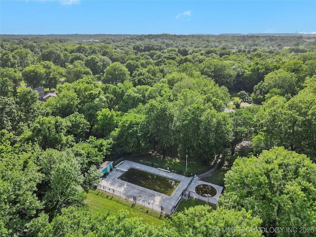 view of subject property with a forest