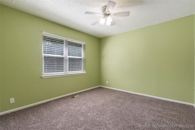 carpeted spare room with a textured ceiling, ceiling fan, and baseboards