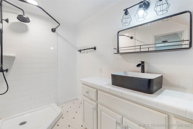 bathroom featuring a shower stall and vanity