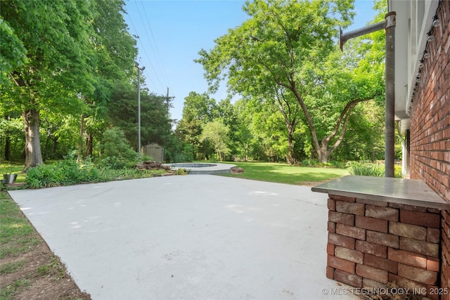 view of patio / terrace featuring view of scattered trees