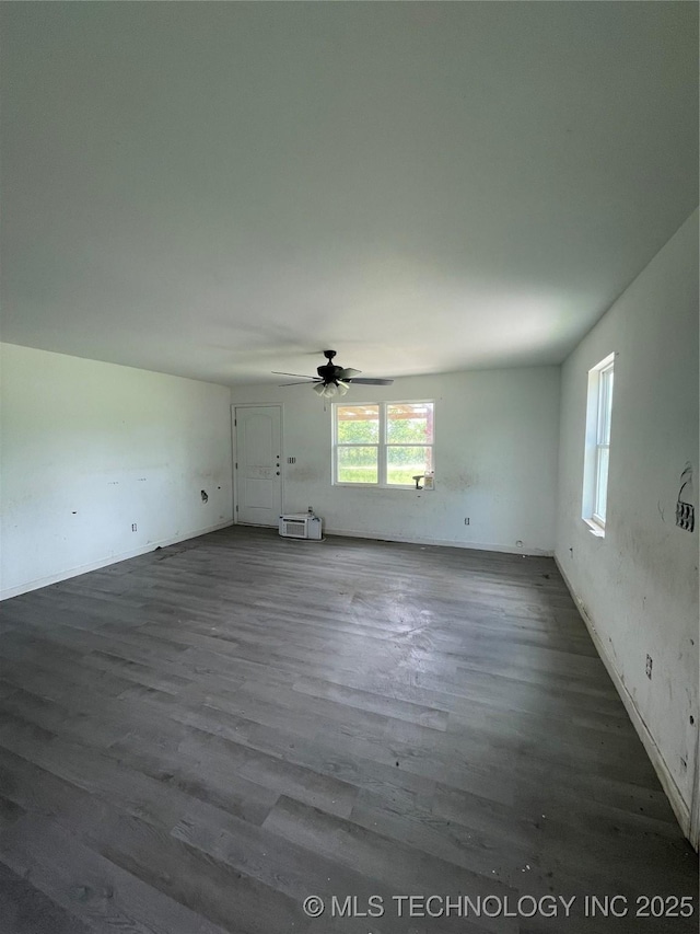 681 Cimmaron, Wilson, OK 73463 - unfurnished living room featuring wood finished floors, a ceiling fan, and baseboards