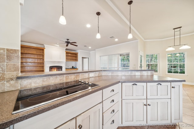 8008 S Juniper Ave, Broken Arrow, OK 74011 - kitchen with black electric cooktop, hanging light fixtures, a ceiling fan, white cabinets, and crown molding