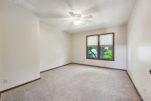 3805 E 64th Pl, Tulsa, OK 74136 - empty room with light colored carpet, a ceiling fan, a textured ceiling, and baseboards