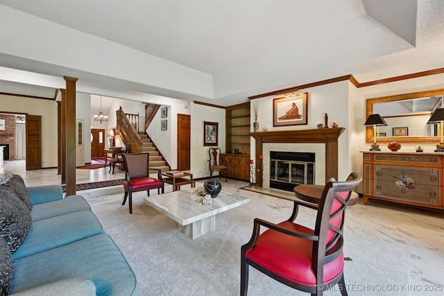 3805 E 64th Pl, Tulsa, OK 74136 - living room with a fireplace, stairway, built in shelves, ornamental molding, and a chandelier