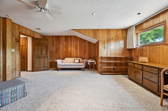 3805 E 64th Pl, Tulsa, OK 74136 - sitting room featuring wood walls, carpet, a textured ceiling, and a ceiling fan