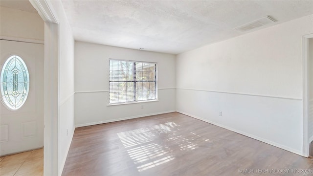 entryway featuring wood finished floors and baseboards
