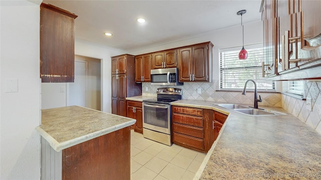 kitchen featuring stainless steel appliances, a sink, ornamental molding, decorative backsplash, and light countertops