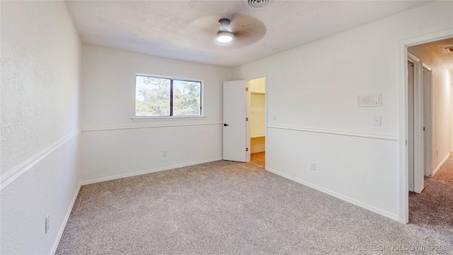 unfurnished bedroom featuring carpet, baseboards, and ceiling fan