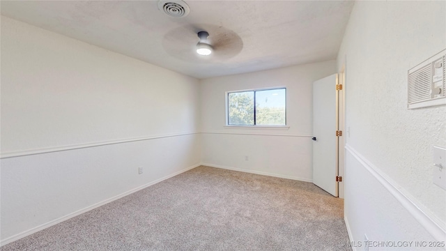 spare room with carpet floors, ceiling fan, and baseboards