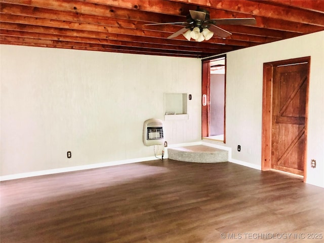 509 N Michigan Ave, Cushing, OK 74023 - unfurnished room featuring dark wood-type flooring, heating unit, beam ceiling, a ceiling fan, and baseboards
