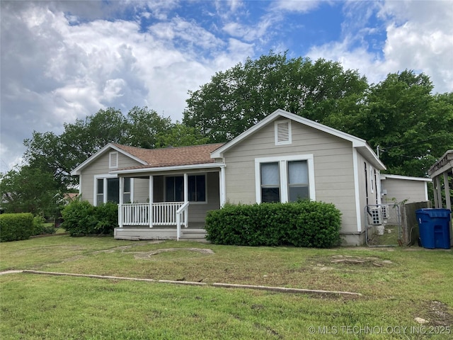 509 N Michigan Ave, Cushing, OK 74023 - ranch-style house with a porch, a front lawn, and a cooling unit