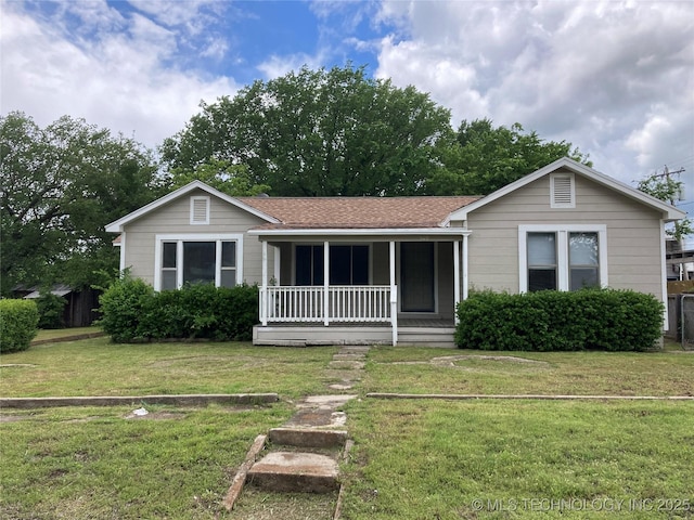 509 N Michigan Ave, Cushing, OK 74023 - ranch-style home featuring covered porch, a front yard, and roof with shingles