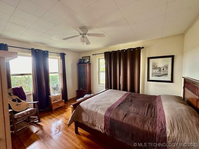 27414 S 4440th Rd, Vinita, OK 74301 - bedroom featuring multiple windows, wood finished floors, and a ceiling fan