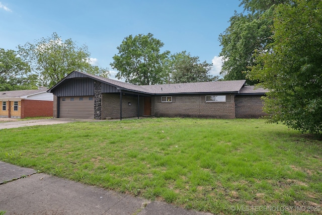 215 Rodman Cir, Muskogee, OK 74403 - single story home with concrete driveway, an attached garage, a front yard, and brick siding