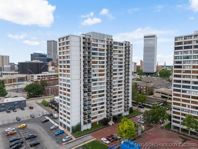 410 W 7th St Unit 1722, Tulsa, OK 74119 - view of building exterior with a view of city and uncovered parking