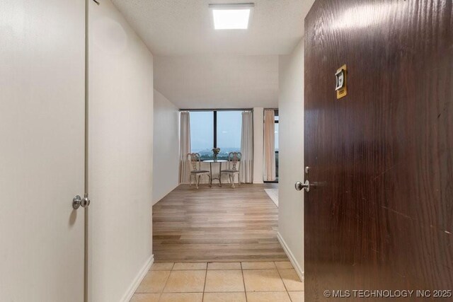 410 W 7th St Unit 1722, Tulsa, OK 74119 - hall with light tile patterned floors and baseboards