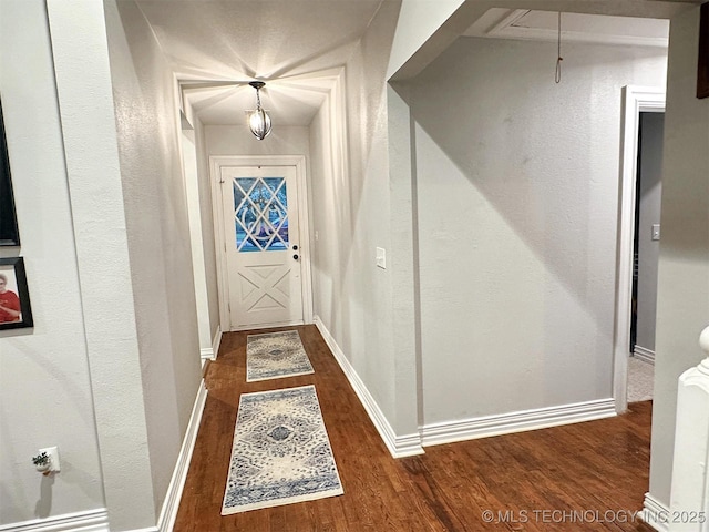 321 W Shawnee St, Tahlequah, OK 74464 - hall with dark wood-style floors, baseboards, and attic access