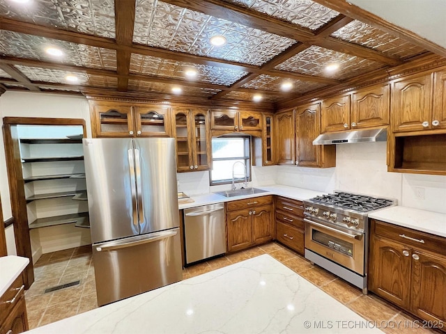 525 W Downing St, Tahlequah, OK 74464 - kitchen featuring stainless steel appliances, a sink, under cabinet range hood, decorative backsplash, and light countertops