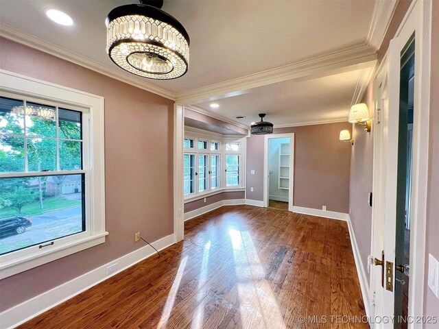 525 W Downing St, Tahlequah, OK 74464 - empty room featuring ornamental molding, wood finished floors, baseboards, and a chandelier