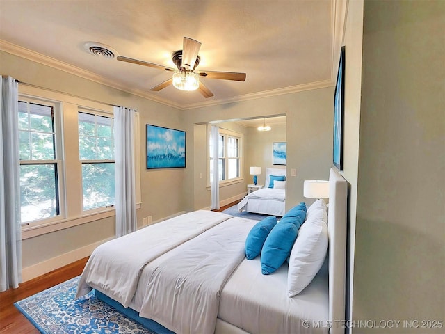 525 W Downing St, Tahlequah, OK 74464 - bedroom featuring baseboards, wood finished floors, ornamental molding, and a ceiling fan