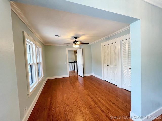 525 W Downing St, Tahlequah, OK 74464 - unfurnished bedroom with crown molding, wood finished floors, baseboards, and ceiling fan