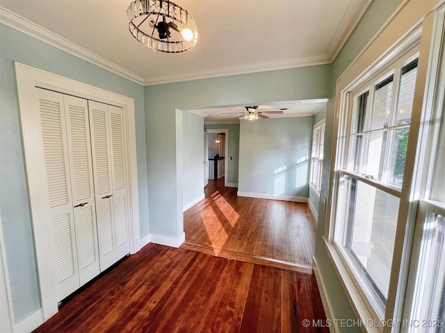 525 W Downing St, Tahlequah, OK 74464 - unfurnished dining area with crown molding, baseboards, hardwood / wood-style flooring, and a ceiling fan