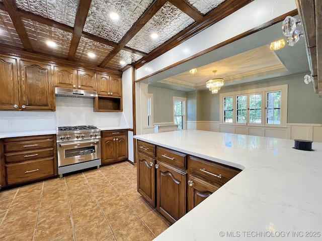 525 W Downing St, Tahlequah, OK 74464 - kitchen featuring stainless steel stove, crown molding, a chandelier, under cabinet range hood, and pendant lighting