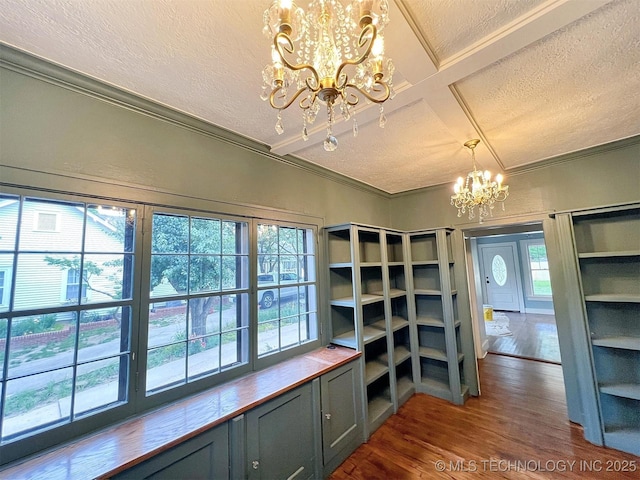 525 W Downing St, Tahlequah, OK 74464 - interior space featuring a chandelier, a textured ceiling, dark wood-type flooring, crown molding, and healthy amount of natural light