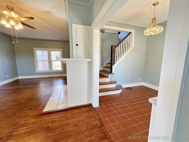 525 W Downing St, Tahlequah, OK 74464 - staircase with baseboards, ceiling fan, wood finished floors, and a chandelier