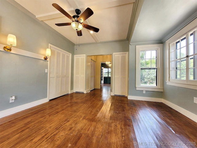 525 W Downing St, Tahlequah, OK 74464 - unfurnished bedroom featuring multiple closets, wood-type flooring, baseboards, crown molding, and a ceiling fan