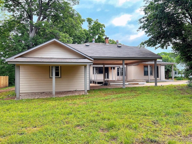 525 W Downing St, Tahlequah, OK 74464 - rear view of property featuring a patio, a lawn, and a shingled roof