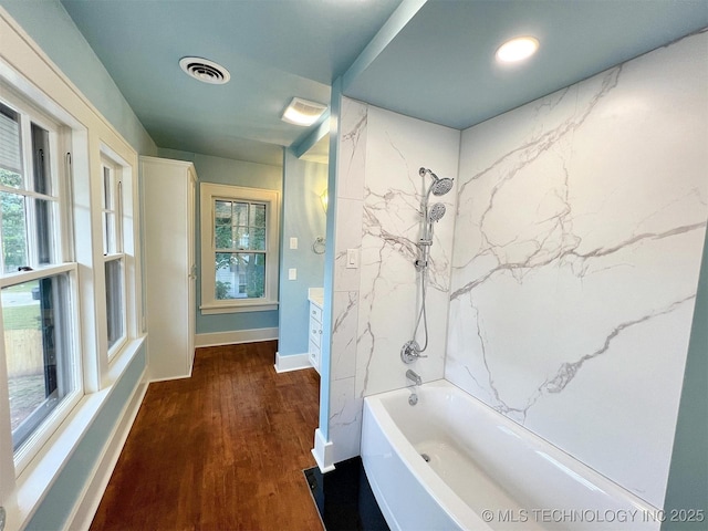 525 W Downing St, Tahlequah, OK 74464 - full bathroom featuring shower / tub combination, wood finished floors, baseboards, and plenty of natural light