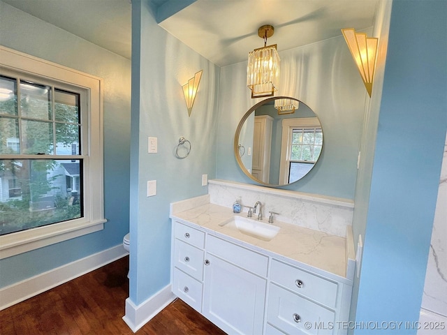 525 W Downing St, Tahlequah, OK 74464 - bathroom with wood finished floors, plenty of natural light, toilet, and a chandelier