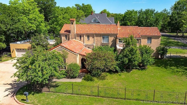 view of front facade with a tile roof, an attached garage, and concrete driveway
