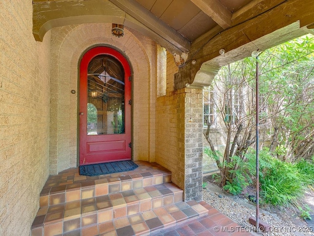 property entrance featuring brick siding