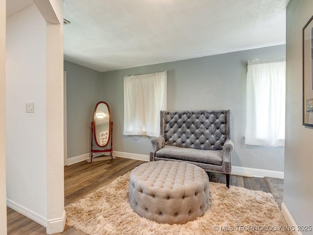 living area featuring wood finished floors and baseboards