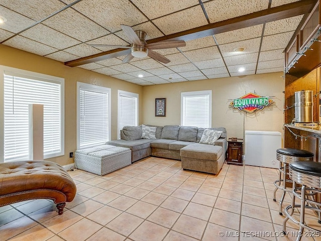 living room featuring light tile patterned floors, ceiling fan, a paneled ceiling, and recessed lighting